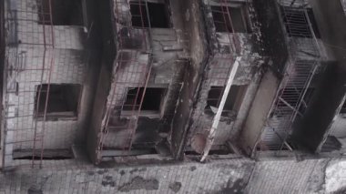 This stock vertical video shows the aftermath of the war in Ukraine - a destroyed residential building in Borodyanka, grey, flat video