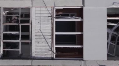 This stock vertical video shows the aftermath of the war in Ukraine - a destroyed residential building in Borodyanka, grey, flat video