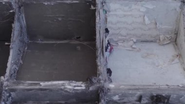 This stock vertical video shows the aftermath of the war in Ukraine - a destroyed residential building in Borodyanka, grey, flat video