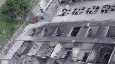 This stock vertical video shows the aftermath of the war in Ukraine - a destroyed residential building in Borodyanka, grey, flat video