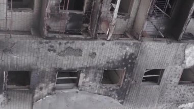 This stock vertical video shows the aftermath of the war in Ukraine - a destroyed residential building in Borodyanka, grey, flat video