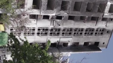 This stock vertical video shows the aftermath of the war in Ukraine - a destroyed residential building in Borodyanka, grey, flat video