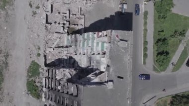 This stock vertical video shows the aftermath of the war in Ukraine - a destroyed residential building in Borodyanka, grey, flat video
