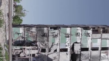 This stock vertical video shows the aftermath of the war in Ukraine - a destroyed residential building in Borodyanka, grey, flat video