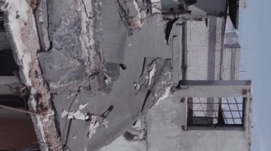 This stock vertical video shows the aftermath of the war in Ukraine - a destroyed residential building in Borodyanka, grey, flat video