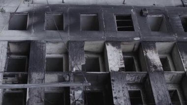This stock vertical video shows the aftermath of the war in Ukraine - a destroyed residential building in Borodyanka, grey, flat video