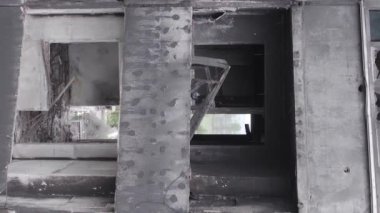 This stock vertical video shows the aftermath of the war in Ukraine - a destroyed residential building in Borodyanka, grey, flat video