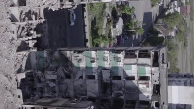 This stock vertical video shows the aftermath of the war in Ukraine - a destroyed residential building in Borodyanka, grey, flat video