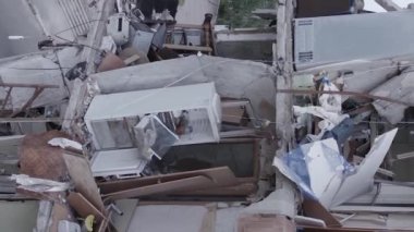 This stock vertical video shows the aftermath of the war in Ukraine - a destroyed residential building in Borodyanka, grey, flat video