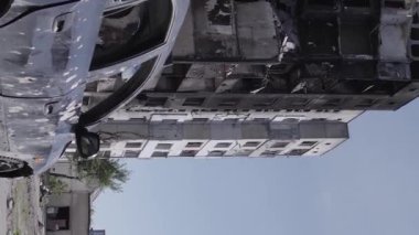 This stock vertical video shows the aftermath of the war in Ukraine - a destroyed residential building in Borodyanka, grey, flat video