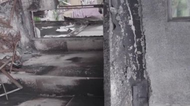 This stock vertical video shows the aftermath of the war in Ukraine - a destroyed residential building in Borodyanka, grey, flat video