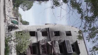 This stock vertical video shows the aftermath of the war in Ukraine - a destroyed residential building in Borodyanka, grey, flat video
