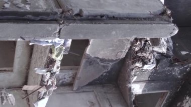 This stock vertical video shows the aftermath of the war in Ukraine - a destroyed residential building in Borodyanka, grey, flat video