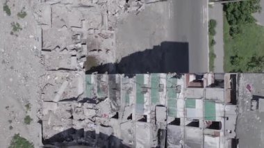 This stock vertical video shows the aftermath of the war in Ukraine - a destroyed residential building in Borodyanka, grey, flat video