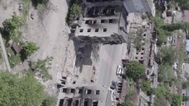This stock vertical video shows the aftermath of the war in Ukraine - a destroyed residential building in Borodyanka, grey, flat video