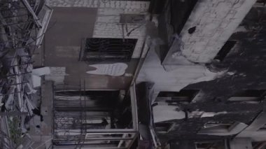 This stock vertical video shows the aftermath of the war in Ukraine - a destroyed residential building in Borodyanka, grey, flat video