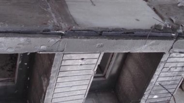 This stock vertical video shows the aftermath of the war in Ukraine - a destroyed residential building in Borodyanka, grey, flat video