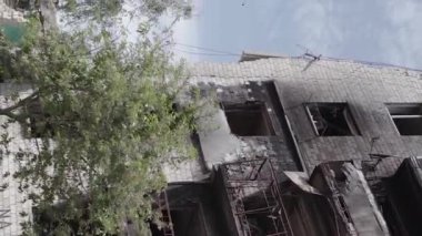 This stock vertical video shows the aftermath of the war in Ukraine - a destroyed residential building in Borodyanka, grey, flat video
