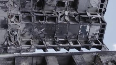 This stock vertical video shows the aftermath of the war in Ukraine - a destroyed residential building in Borodyanka, grey, flat video
