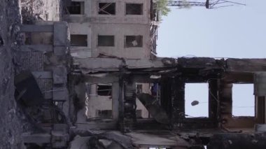 This stock vertical video shows the aftermath of the war in Ukraine - a destroyed residential building in Borodyanka, grey, flat video