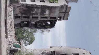 This stock vertical video shows the aftermath of the war in Ukraine - a destroyed residential building in Borodyanka, grey, flat video