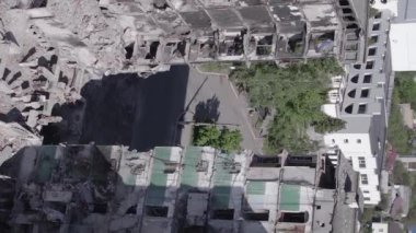 This stock vertical video shows the aftermath of the war in Ukraine - a destroyed residential building in Borodyanka, grey, flat video