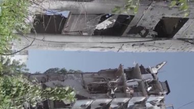 This stock vertical video shows the aftermath of the war in Ukraine - a destroyed residential building in Borodyanka, grey, flat video