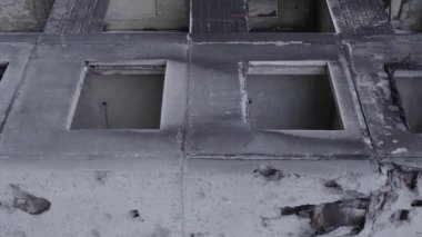 This stock vertical video shows the aftermath of the war in Ukraine - a destroyed residential building in Borodyanka, grey, flat video