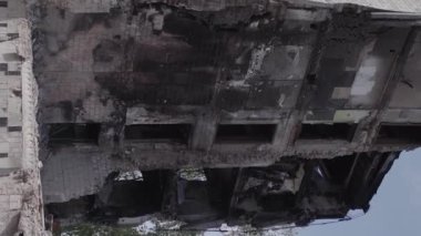 This stock vertical video shows the aftermath of the war in Ukraine - a destroyed residential building in Borodyanka, grey, flat video