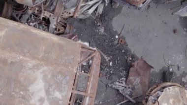 This stock vertical video shows a dump of shot and burned cars in Irpin, Bucha district , grey, flat video