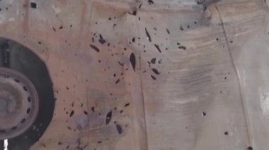 This stock vertical video shows a dump of shot and burned cars in Irpin, Bucha district , grey, flat video