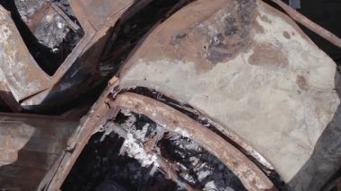 This stock vertical video shows a dump of shot and burned cars in Irpin, Bucha district , grey, flat video