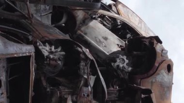 This stock vertical video shows a dump of shot and burned cars in Irpin, Bucha district , grey, flat video