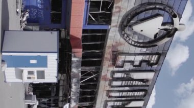 This stock vertical video shows a destroyed building of a shopping center in Bucha during the war in Ukraine, grey, flat video