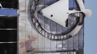 This stock vertical video shows a destroyed building of a shopping center in Bucha during the war in Ukraine, grey, flat video
