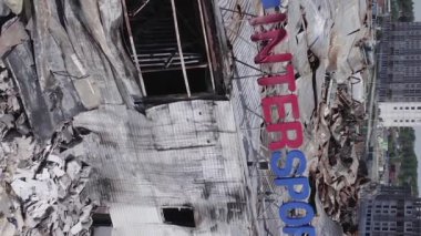 This stock vertical video shows a destroyed building of a shopping center in Bucha during the war in Ukraine, grey, flat video