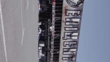 This stock vertical video shows a destroyed building of a shopping center in Bucha during the war in Ukraine, grey, flat video