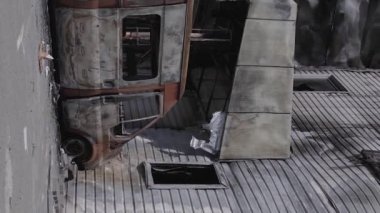 This stock vertical video shows a destroyed building of a shopping center in Bucha during the war in Ukraine, grey, flat video