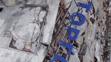 This stock vertical video shows a destroyed building of a shopping center in Bucha during the war in Ukraine, grey, flat video