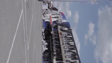 This stock vertical video shows a destroyed building of a shopping center in Bucha during the war in Ukraine, grey, flat video