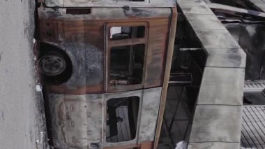 This stock vertical video shows a destroyed building of a shopping center in Bucha during the war in Ukraine, grey, flat video