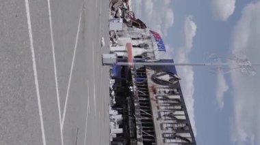 This stock vertical video shows a destroyed building of a shopping center in Bucha during the war in Ukraine, grey, flat video