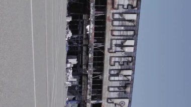 This stock vertical video shows a destroyed building of a shopping center in Bucha during the war in Ukraine, grey, flat video