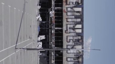 This stock vertical video shows a destroyed building of a shopping center in Bucha during the war in Ukraine, grey, flat video