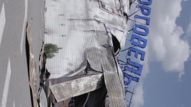 This stock vertical video shows a destroyed building of a shopping center in Bucha during the war in Ukraine, grey, flat video