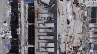 This stock vertical video shows a destroyed building of a shopping center in Bucha during the war in Ukraine, grey, flat video