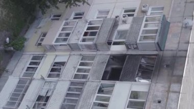 This stock vertical video shows a destroyed building in the city of Makariv during the war in Ukraine, grey, flat video