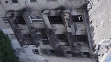This stock vertical video shows a destroyed building in the city of Makariv during the war in Ukraine, grey, flat video