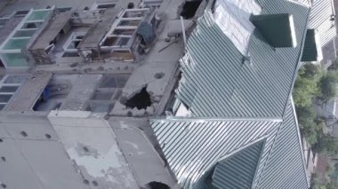 This stock vertical video shows a destroyed building in the city of Makariv during the war in Ukraine, grey, flat video