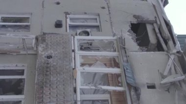 This stock vertical video shows a destroyed building in the city of Makariv during the war in Ukraine, grey, flat video